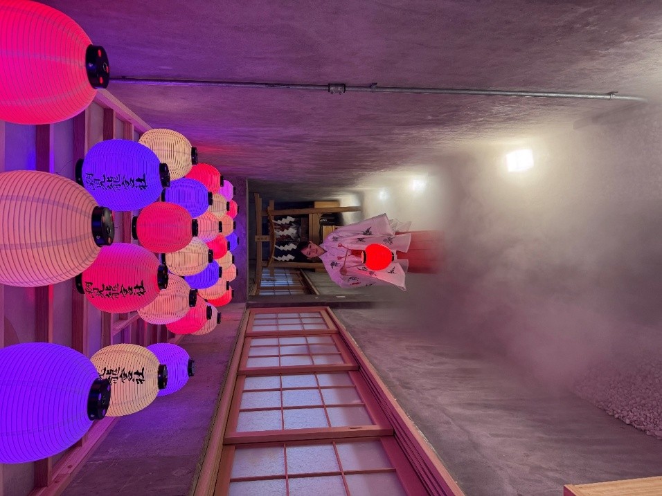 穿過燈籠懸垂的長廊，薄霧如雲般氤氳，光影交錯之間營造出夢幻又神祕的通道，彷彿引領訪客走入另一段時空。