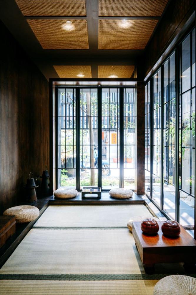 室內光線柔和，牆面帶著接近土壤的色調，搭配木質與藤編元素，營造出近似咖啡樹生長環境的氛圍。